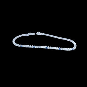 Riviere bracelet in 18K white gold with 2.05ct sapphires and 3.43ct zircons. Elegant, luminous, and 7.5g in weight.