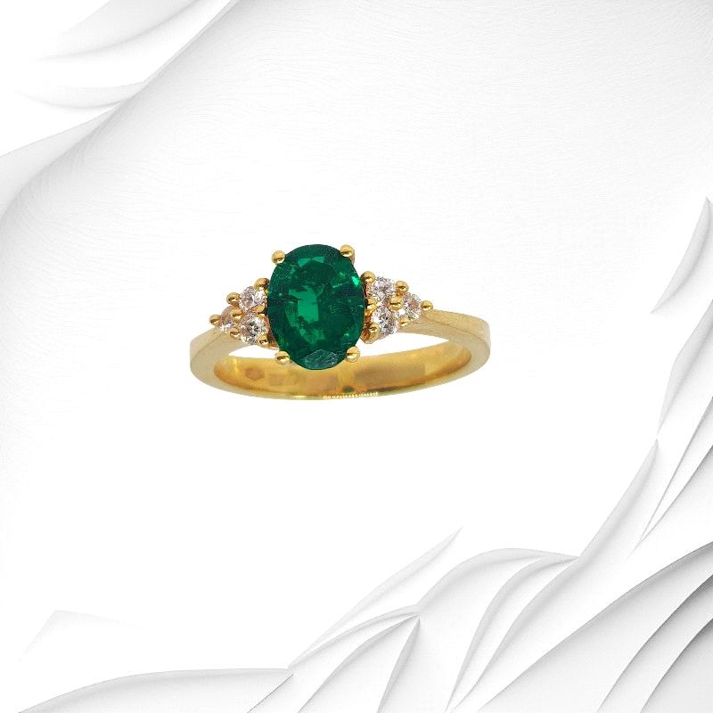 18K yellow gold ring with 1.21ct oval emerald and six diamonds. Weight: 0.15ct total.